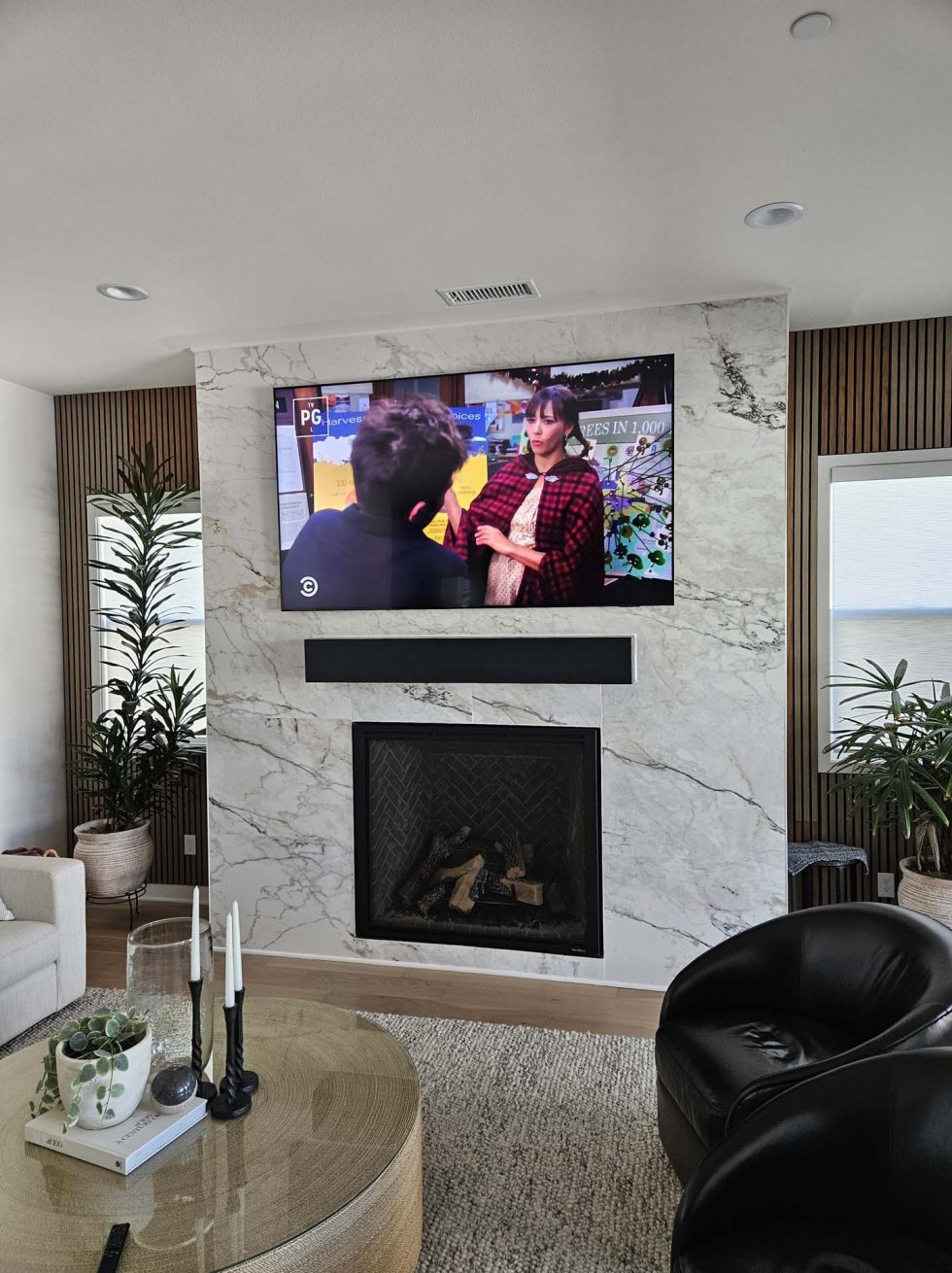 TV on marble over fireplace